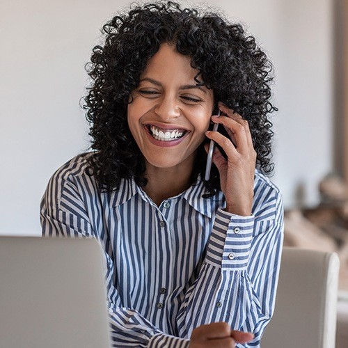 Smiling woman answering the phone