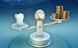 Tooth and coins on a balance scale