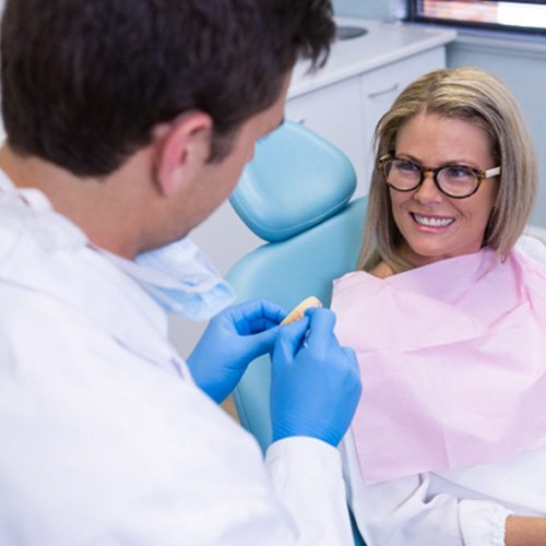 woman talking to dentist about cosmetic dentistry 