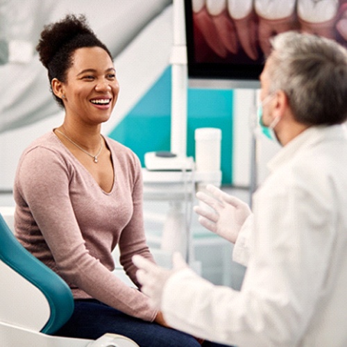 Patient and dentist discussing types of dental bridges in Lacey