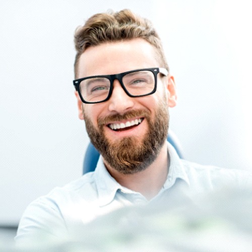 Smiling man with dental crowns in Lacey