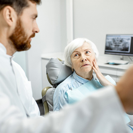 Woman with dental implants in Lacey speaking with a dentist
