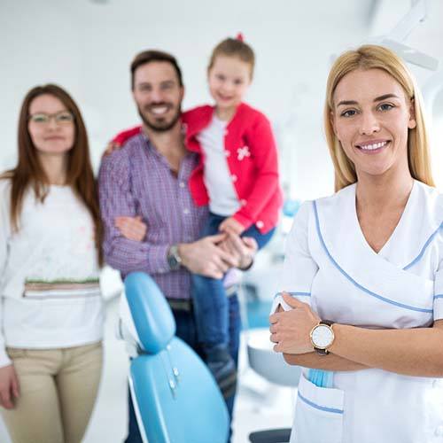 Family smiling with emergency dentist
