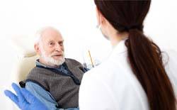 Man listening to dentist in Lacey