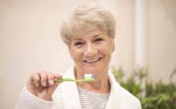 Woman holding toothbrush in Lacey