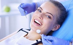 Woman smiling while visiting implant dentist in Lacey