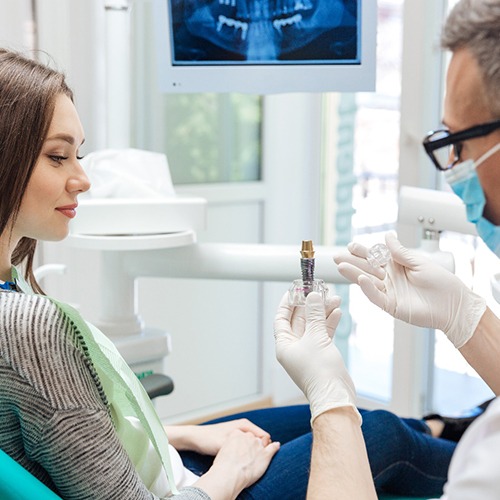 dentist explaining dental implants in Lacey to patient