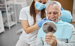 mature man smiling after getting dental implants in Lacey 