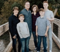 Dentist in Lacey standing on a bridge with family