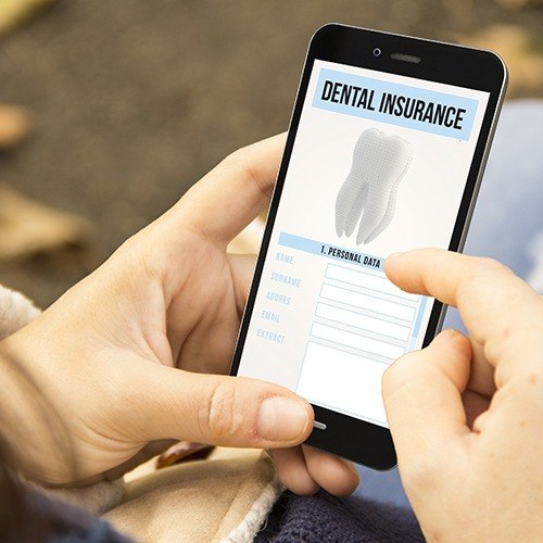 Patient using smartphone to complete dental insurance forms