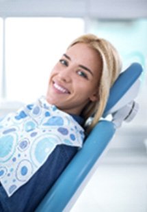 Woman smiling during dental checkup with Olympia dentist