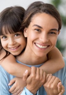 Mom and daughter hugging on couch at home