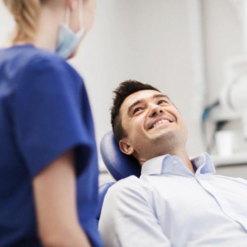 male patient smiling in dental chair 