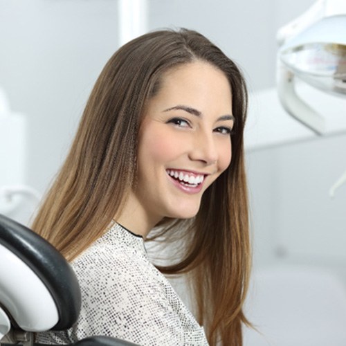 female patient smiling in dental chair 
