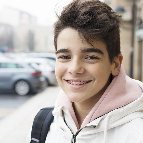 Teen with traditional braces smiling