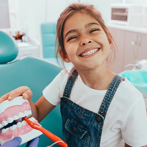 Smiling child practicing tooth brushing