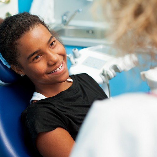 Little girl smiling after dental sealants