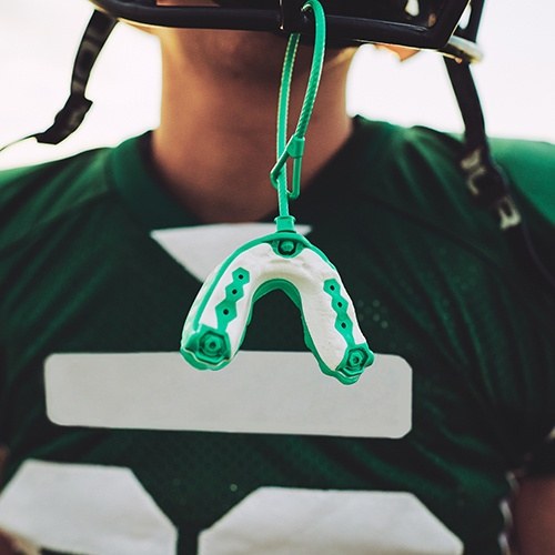 Athletic mouthguard hanging from a football helmet