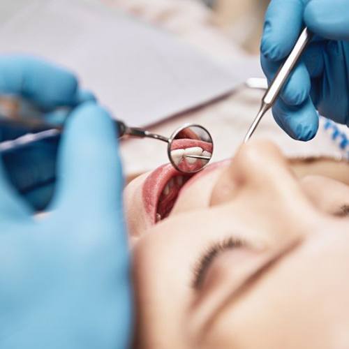 Close up of dentist examining a patient’s mouth