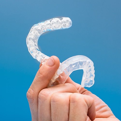 Hand holding set of nightguards for bruxism
