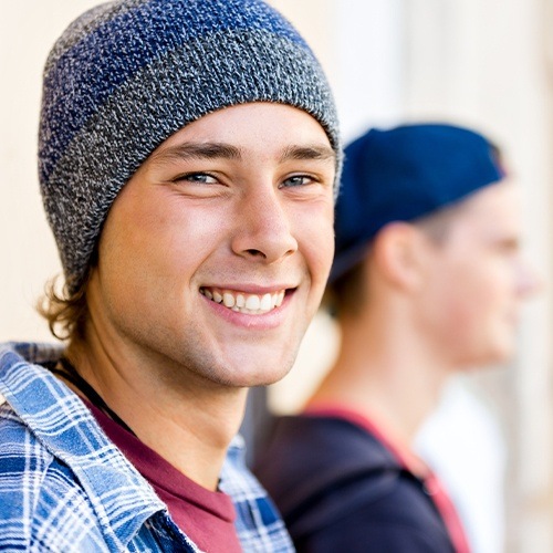 Young man with dental sealants smiling