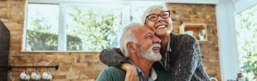 Couple smiling together after restorative dentistry visit