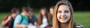 Young woman with braces smiling