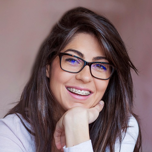 Young woman wearing traditional braces in Lacey
