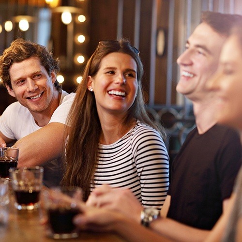 Woman laughing with friends after professional teeth whitening