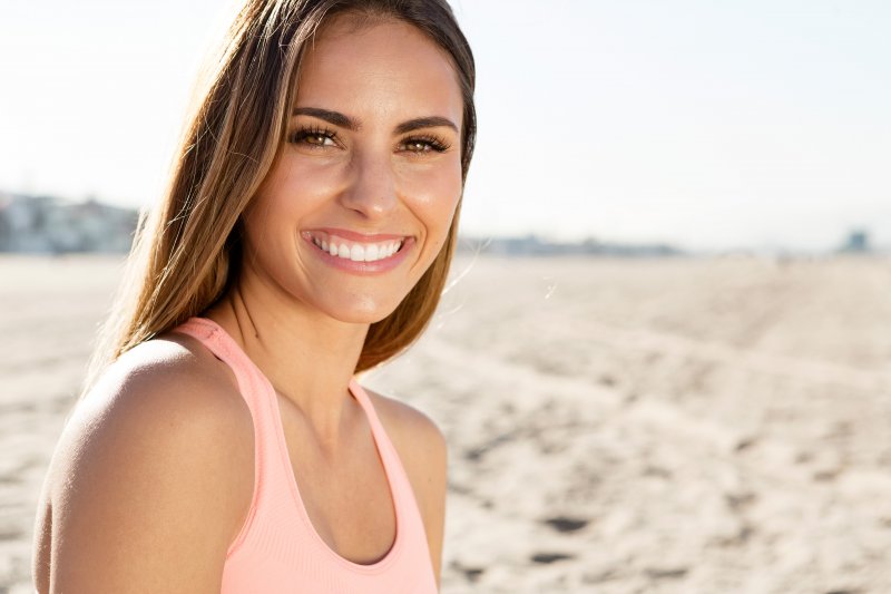 young woman smiling on the beach