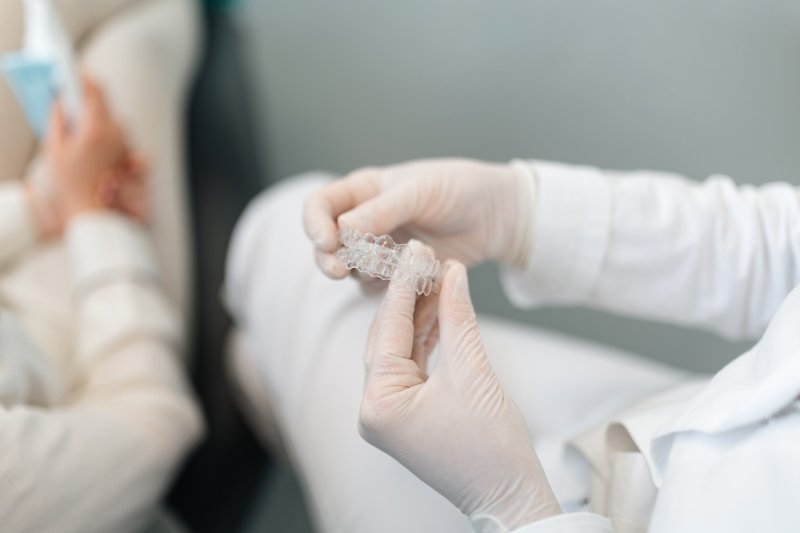 dentist holding two clear aligners