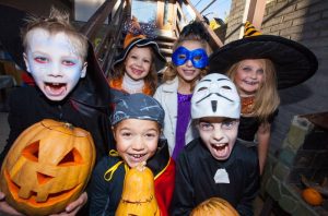 A group of kids dressed in Halloween costumes.