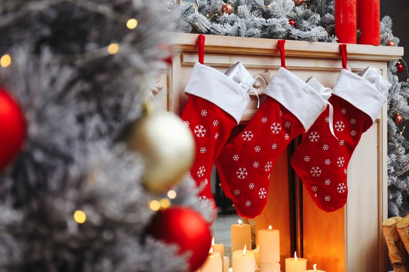 Festive room with stockings hanging over fireplace